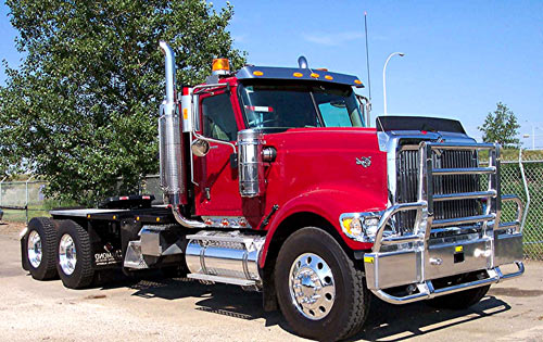 Red semi truck fitted with a polished aluminum Bison Grille Guard